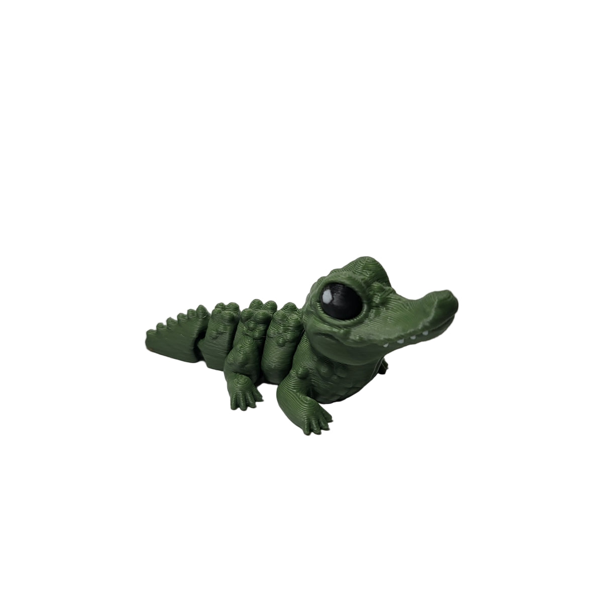Green alligator on a white surface