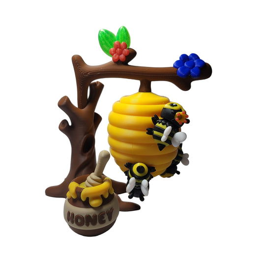 Toy beehive with bees and a honey pot.